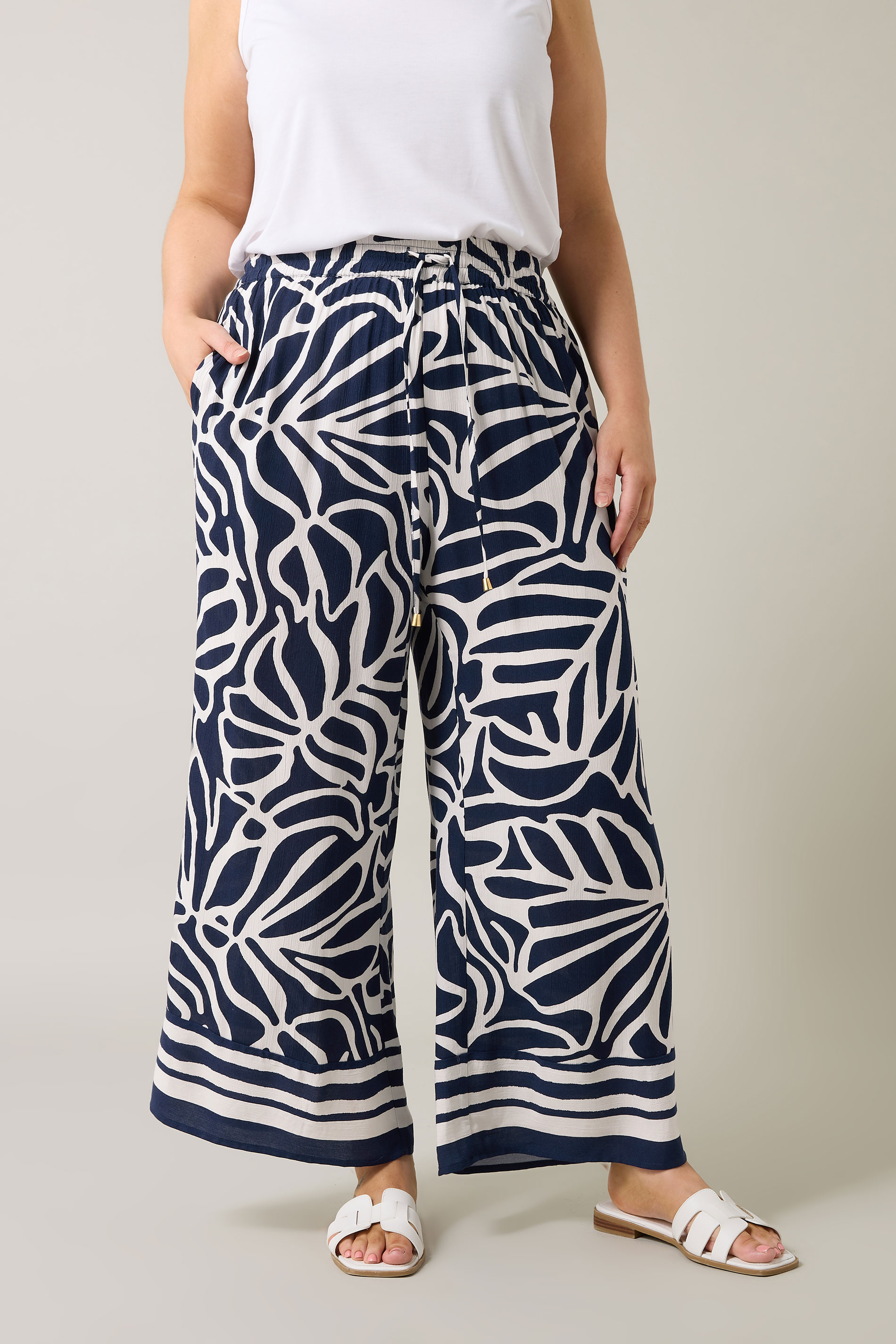 EVANS Plus Size Navy Blue Palm Border Print Trousers | Evans 1