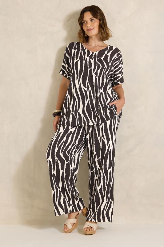 EVANS Plus Size Chocolate Brown Zebra Print Wide Leg Trouser | Evans 1