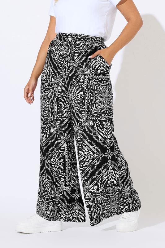 YOURS Plus Size Black Bandana Print Textured Wide Leg Trousers | Yours Clothing 1