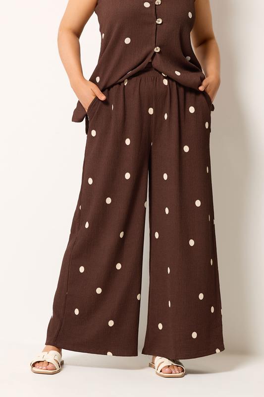 YOURS Plus Size Chocolate Brown Polka Dot Crinkle Trousers | Yours Clothing 1