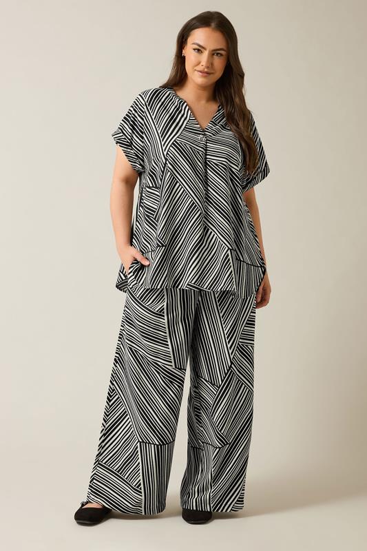 EVANS Plus Size Black Stripe Print Wide Leg Trousers | Evans 1