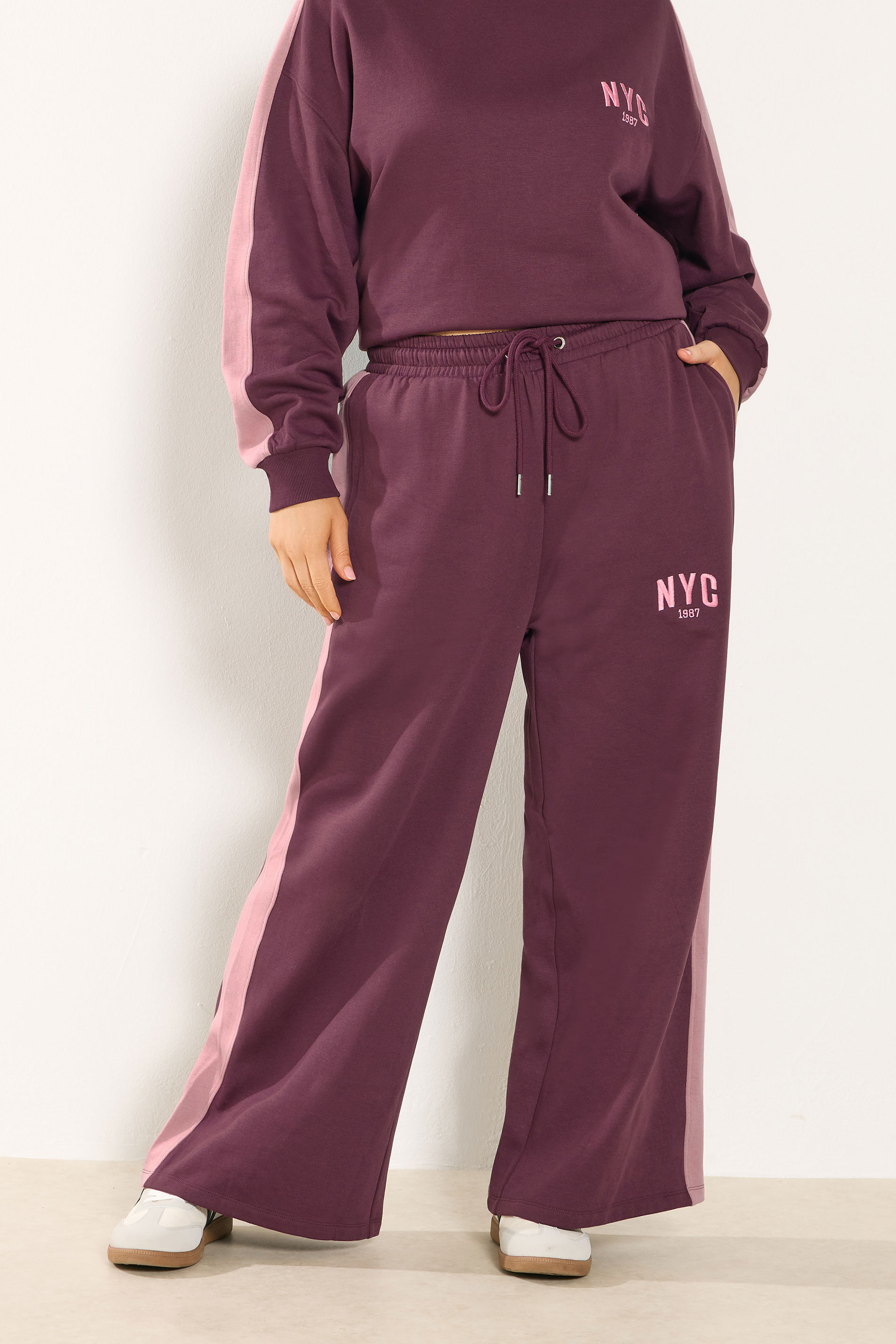 YOURS Plus Size Burgundy Red 'NYC' Side Stripe Wide Leg Joggers | Yours Clothing 1